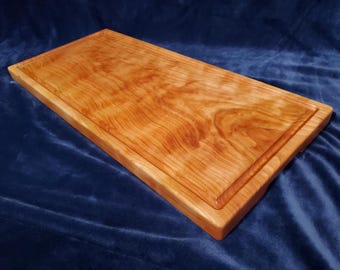 12 1/2" x 27" x 1 3/8" Solid Curly Cherry Wood Cutting Board with Juice Groove, Handles & Leveling Feet