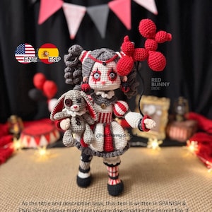 May include: A crocheted doll featuring grey hair, red and white striped clothing, and dark makeup around the eyes. The doll holds a small grey crocheted rabbit and a red balloon animal. Text on the image includes RED BUNNY CROCHET and @redbunny.crochet.