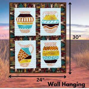 May include: A quilted wall hanging featuring four panels with colorful, stylized pottery designs. The wall hanging is 24 inches wide and 30 inches tall. The border has a patterned design with the words "Wall Hanging" at the bottom.