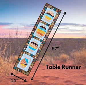 May include: A rectangular table runner with a Native American design. The runner is 57 inches long and 14 inches wide. It features four rectangular panels with colorful pottery designs on a light blue background, framed by a patterned border.