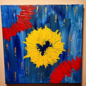 May include: Abstract acrylic painting on canvas. The artwork features a vibrant yellow floral shape at the center, with red brushstrokes and gold accents against a blue background. The painting is square and mounted on a wooden frame.