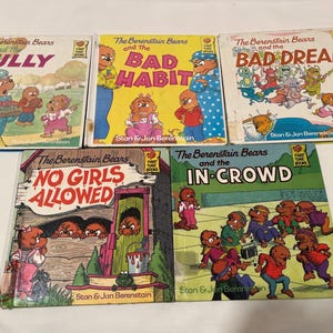 May include: A collection of five children's books featuring the Berenstain Bears. The books are titled "The Berenstain Bears and the Bully", "The Berenstain Bears and the Bad Habit", "The Berenstain Bears and the Bad Dream", "The Berenstain Bears and No Girls Allowed", and "The Berenstain Bears and the In-Crowd".