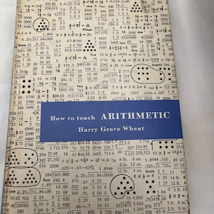 May include: A vintage book cover titled "How to Teach Arithmetic" by Harry Grove Wheat. The cover is a mix of beige and blue, with mathematical equations and calculations printed on it.