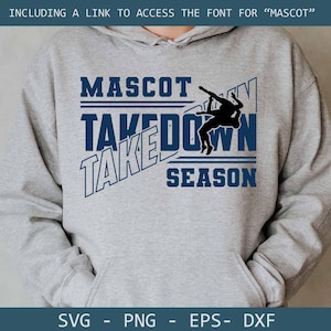 May include: A grey hooded sweatshirt featuring the text "MASCOT TAKEDOWN SEASON" in blue. A silhouette of two wrestlers is in the center. The bottom of the hoodie has the words "SVG - PNG - EPS - DXF".