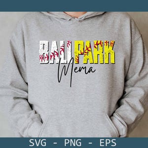 May include: A gray hooded sweatshirt with the words "BALL PARK Mema" in a distressed font. The word "BALL PARK" is in white and yellow, with baseball stitching details. The word "Mema" is in a black script font.