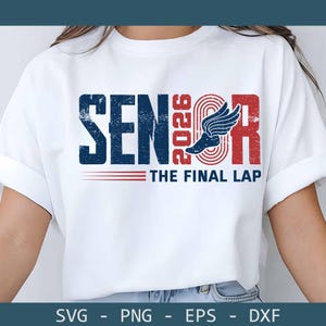 May include: White t-shirt with a distressed design featuring the word "SENIOR" in navy blue, the year "2026" in red, and a winged track shoe graphic. Below, the text reads "THE FINAL LAP" in red. The design is a vintage style.