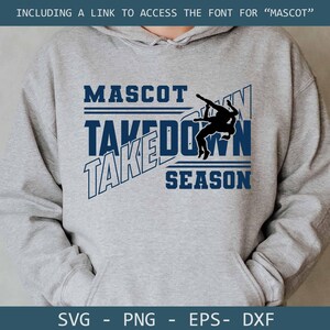 May include: A gray hoodie with the words "MASCOT TAKEDOWN SEASON" in navy blue. A silhouette of two wrestlers is in the center. The bottom of the hoodie has the file types: SVG, PNG, EPS, and DXF.