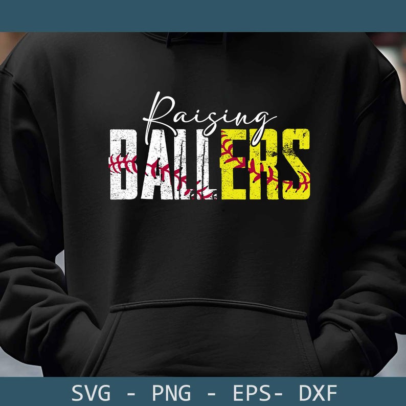 May include: Black hoodie with the words "Raising Ballers" in white and yellow. The word "Ballers" is designed with a softball theme, featuring red stitching. The hoodie is a comfortable apparel item.
