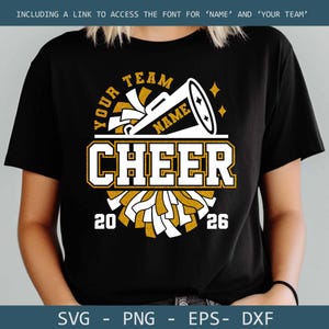May include: Black t-shirt with a cheerleading design. The design includes the words "YOUR TEAM NAME CHEER 20 26" in gold and white. A megaphone and pom-poms are also featured in the design. The shirt also includes the text "SVG - PNG - EPS - DXF".