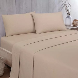 May include: A beige bed with a fitted sheet and two pillowcases. The bed is made with a soft, textured fabric.