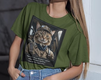 May include: A woman wearing a green t-shirt with a cat wearing a pilot's uniform and goggles. The cat is in a cockpit and the text on the shirt reads: "Mike Echo Oscar Whiskey! I repeat - Mike Echo Oscar Whiskey! How do you copy?! Over"