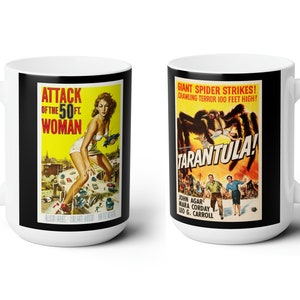 May include: Two white ceramic mugs with black handles. The mug on the left features a vintage movie poster for "Attack of the 50ft Woman". The mug on the right features a vintage movie poster for "Tarantula!" with the text "Giant Spider Strikes! Crawling Terror 100 Feet High!"