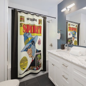May include: A shower curtain featuring a vintage comic book cover of "The Spirit" with a blue and yellow color scheme. The cover features a masked man in a fedora and a suit, with the text "The Star Ledger" and "The Spirit" in bold, red letters.
