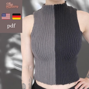 Puede incluir: Una camiseta sin mangas de cuello alto con un diseño vertical de dos tonos, con el lado izquierdo gris y el lado derecho negro. La prenda está confeccionada con una textura de ganchillo acanalada que cubre todo el torso.