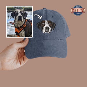May include: A blue denim baseball cap with an embroidered image of a black and white dog's head. The text "Don't My Time Est. 2023" is embroidered on the back of the cap.