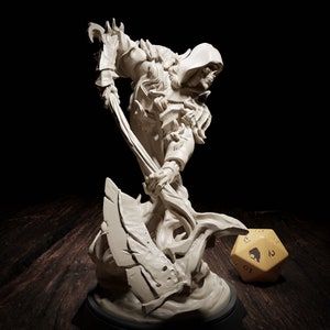 May include: An off-white sculpture of a skeletal figure in hooded armour, wielding a large scythe. The figure is dynamically posed, with a large, multi-sided die in the background. The sculpture is set against a dark background.