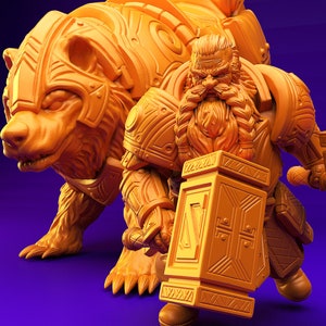 May include: A miniature figurine of a dwarf warrior holding a large hammer, standing next to a bear-like creature with intricate armour. Both figures are made of a golden-brown plastic.