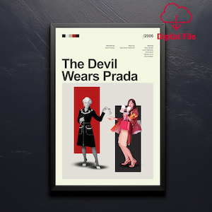 May include: A framed movie poster for "The Devil Wears Prada" with a black frame. The poster features the movie title, the year 2006, and two women. One woman is in a black coat, and the other is holding shopping bags.