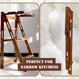 May include: A wooden step stool with a fold-down design. The stool has three steps and a top platform. The stool is brown and has a natural wood finish. The stool is folded up and standing on its side. The text "PERFECT FOR NARROW KITCHENS" is visible in the image.