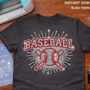 May include: Dark gray t-shirt with a baseball design. The word "BASEBALL" is in red rhinestones above a baseball and crossed bats design. The design is surrounded by white rhinestones. An SVG file and a cutting machine are in the background.