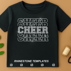 May include: Black t-shirt with the word "CHEER" in rhinestone letters. The word "CHEER" is stacked between the words "RUGGED" and "GREEN". The phrase "RHINESTONE TEMPLATES" is printed at the bottom of the shirt.