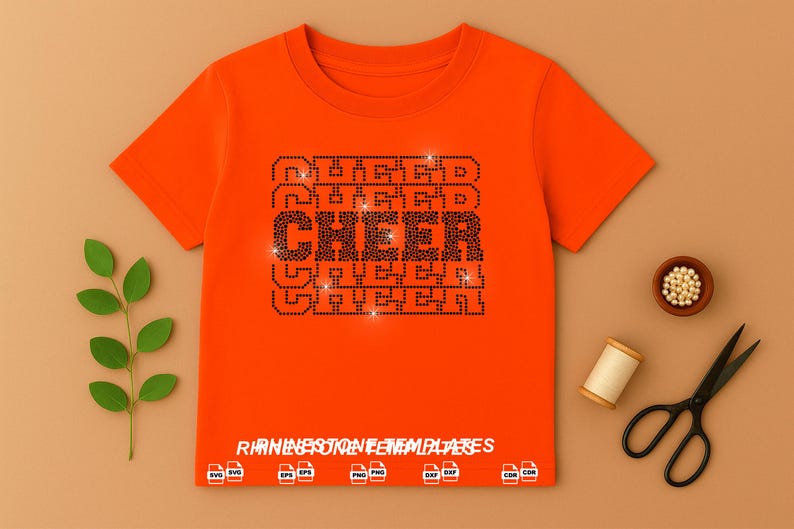 May include: A bright orange short-sleeved t-shirt featuring a central graphic design made of black rhinestones that spells the word CHEER in a bold, block font. The text RHINESTONE TEMPLATES is printed at the bottom with various file format icons.