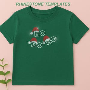 May include: Green t-shirt with a festive design. The shirt features the text "HO HO HO" spelled out with sparkling rhinestones and Santa hats. The words are arranged in a playful, circular pattern, perfect for the holiday season.