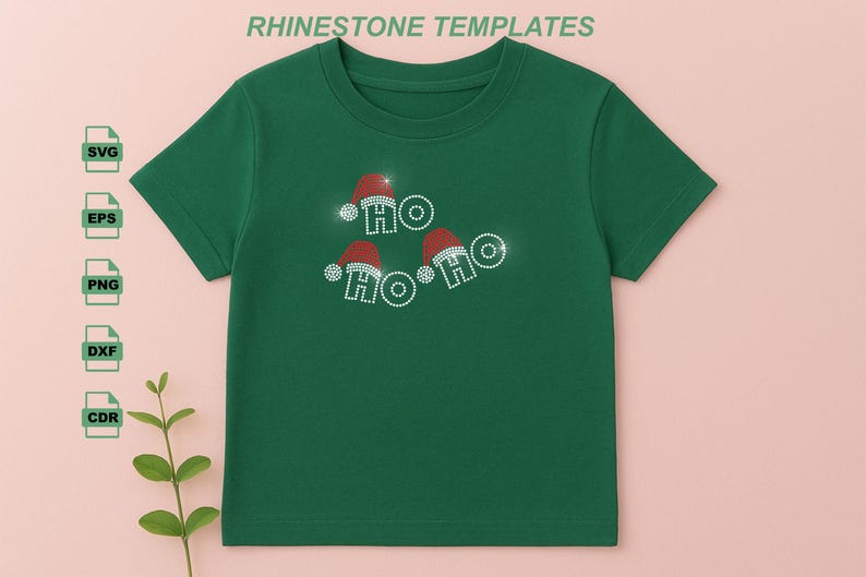 May include: Green t-shirt with a festive design. The shirt features the text "HO HO HO" spelled out with sparkling rhinestones and Santa hats. The words are arranged in a playful, circular pattern, perfect for the holiday season.