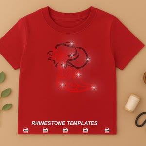 May include: A red t-shirt featuring a rhinestone design of a stylized ram's head with star accents. The text "RHINESTONE TEMPLATES" is printed at the bottom. Additional items include scissors, a spool of thread, and a small bowl of beads.