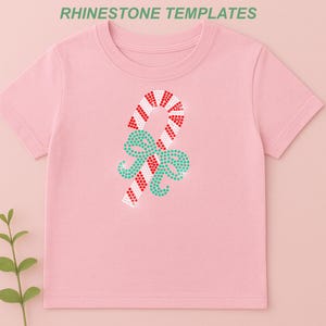 May include: Pink t-shirt featuring a candy cane and bow design made of red, white, and teal rhinestones. The text "RHINESTONE TEMPLATES" is at the top. Includes SVG, EPS, PNG, DXF, and CDR file icons.