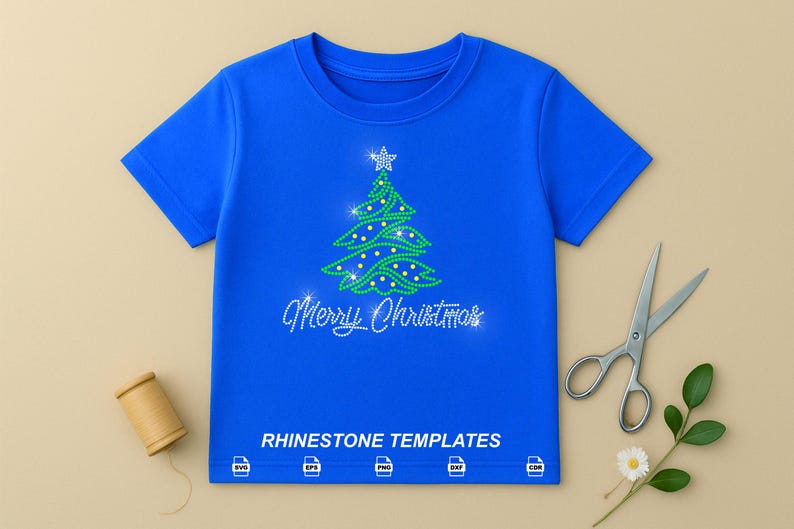 May include: A bright blue short-sleeved t-shirt featuring a green rhinestone Christmas tree graphic with a star on top and the text Merry Christmas in white rhinestones. Below the text, the words RHINESTONE TEMPLATES appear with five file format icons.