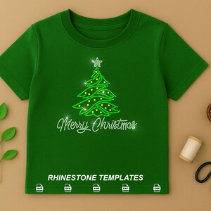 May include: A dark green short-sleeved t-shirt featuring a rhinestone graphic of a Christmas tree topped with a star and the text Merry Christmas. Below the text, the words RHINESTONE TEMPLATES appear with five file format icons.