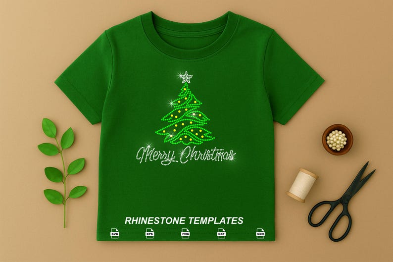 May include: A dark green short-sleeved t-shirt featuring a rhinestone graphic of a Christmas tree topped with a star and the text Merry Christmas. Below the text, the words RHINESTONE TEMPLATES appear with five file format icons.