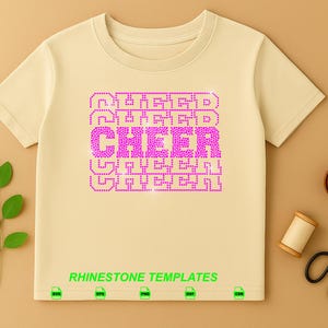 May include: A light beige short-sleeved t-shirt featuring a central graphic of the word CHEER repeated in a stacked pattern, rendered in bright pink rhinestones. The text RHINESTONE TEMPLATES appears in green below the graphic with file icons.