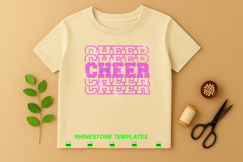 May include: A light beige short-sleeved t-shirt featuring a central graphic of the word CHEER repeated in a stacked pattern, rendered in bright pink rhinestones. The text RHINESTONE TEMPLATES appears in green below the graphic with file icons.