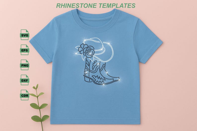 May include: Light blue t-shirt featuring a rhinestone design of a cowboy boot, hat, and rose. The design is made of sparkling rhinestones. The text "RHINESTONE TEMPLATES" is at the top of the image.