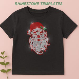 May include: Black t-shirt featuring a rhinestone design of Santa Claus. The Santa design includes a red hat, white beard, and a smiling face. The shirt is a festive item for the holiday season.