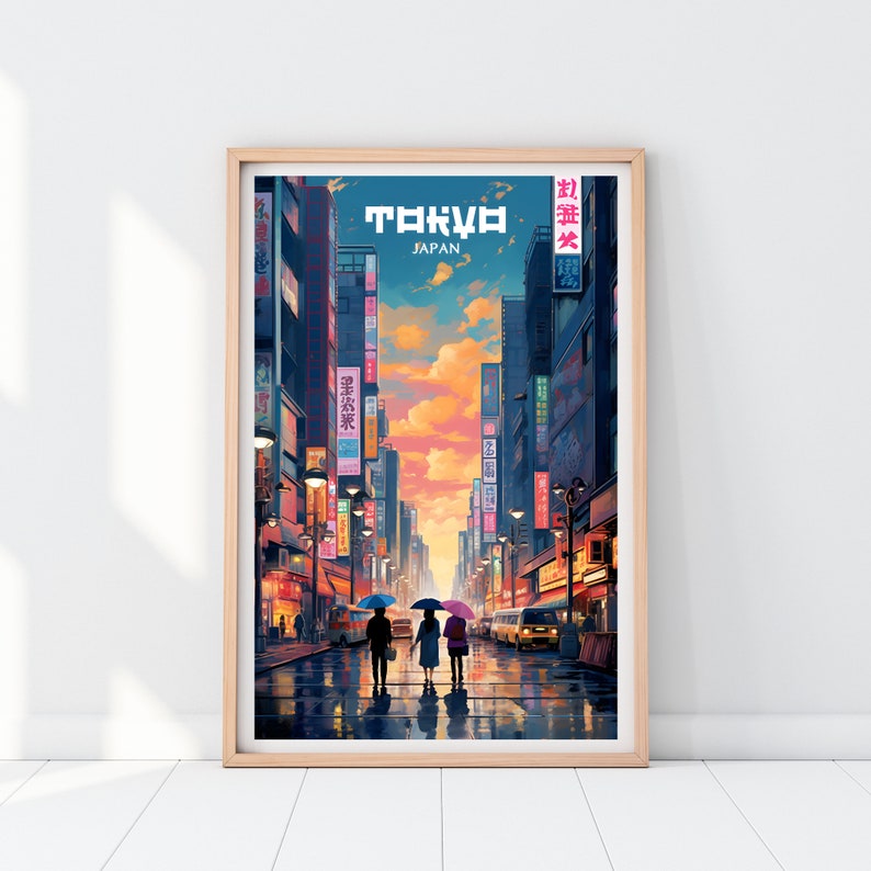 May include: A framed poster with a colorful illustration of a street in Tokyo, Japan. The poster features a sunset sky, tall buildings, and three people walking under umbrellas. The text "TOKYO" and "JAPAN" is printed on the poster.