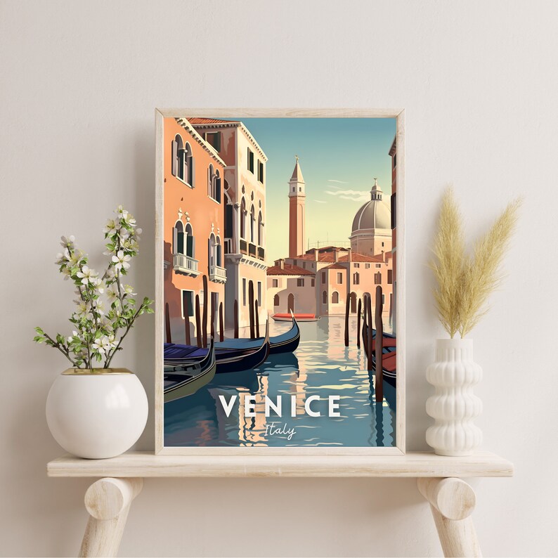 May include: A vintage travel poster featuring a colorful illustration of a canal in Venice, Italy. Gondolas are docked along the canal, with buildings lining the water's edge. The text "VENICE Italy" is at the bottom of the poster.