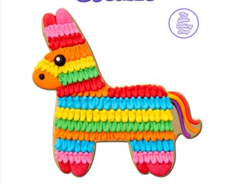 May include: A donkey-shaped piñata cookie design featuring horizontal rows of colorful icing in red, pink, orange, yellow, green, and blue. The text 31 SIZES and STL+PNG GUIDE appears in purple. A circular logo reads The Little Cutting Shop.