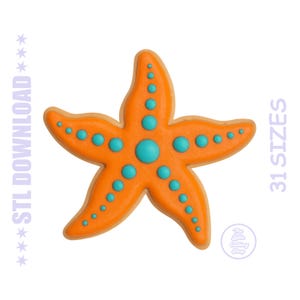 May include: An orange starfish-shaped cookie with a light tan border and raised teal dots along each of its five arms. The text STL DOWNLOAD and 31 SIZES is visible on the sides, with a small circular logo reading The Little Cutting Shop.