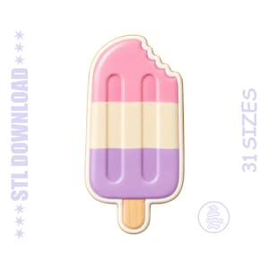 May include: A three-tiered popsicle-shaped cookie cutter with a bite mark at the top. The design features pink, cream, and purple horizontal sections with a wooden-colored stick at the base. Text reads STL DOWNLOAD and 31 SIZES.