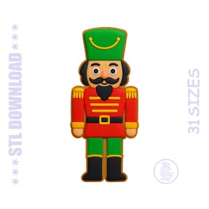 May include: A colorful, cartoon-style nutcracker figure with a green hat, red jacket, and black boots. The image includes the text "STL DOWNLOAD" and "31 SIZES". A small circular logo is also visible.