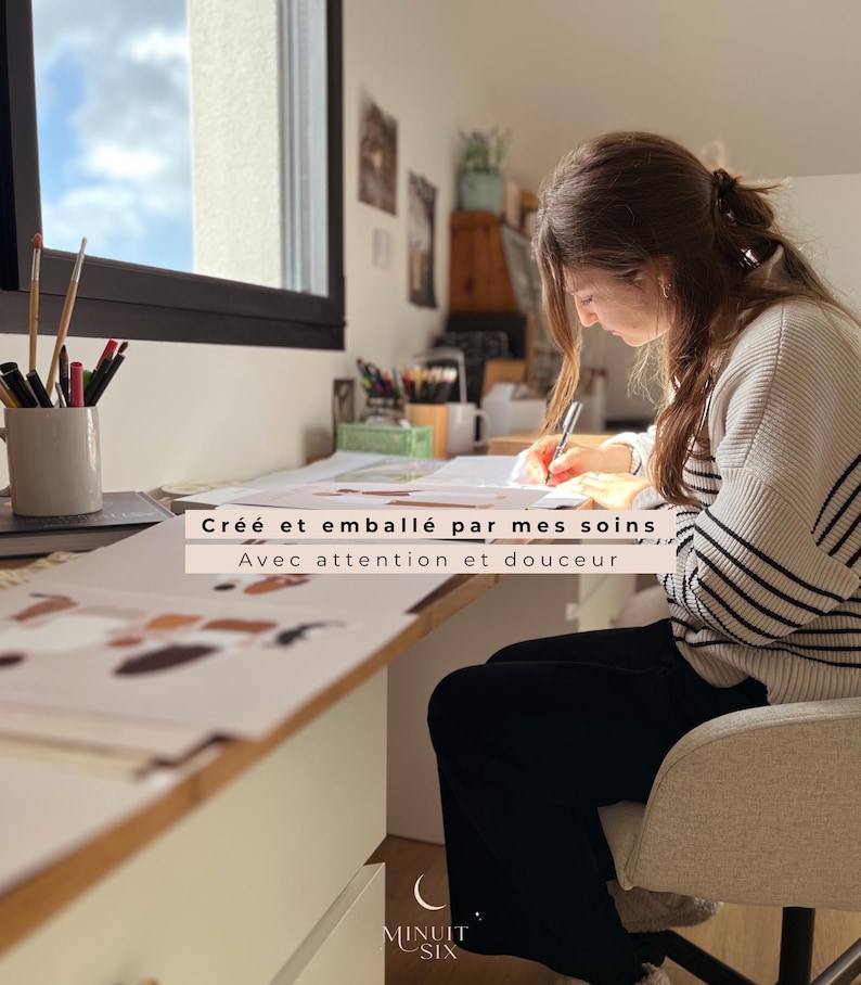 May include: A person seated at a desk, writing on paper. The desk holds art supplies and a mug with pens and brushes. The text on the image reads "Cr&eacute;&eacute; et emball&eacute; par mes soins Avec attention et douceur" and the logo for "Minuit Six" is at the bottom.