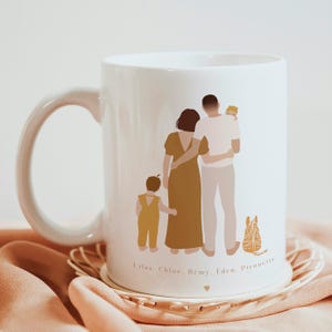 May include: White ceramic mug with a family portrait illustration. The illustration features a couple with two children and a pet. The text at the bottom reads "Lilas, Chloe, Remy, Eden, Pirouette".