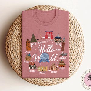 a pink t - shirt with the words hello world on it