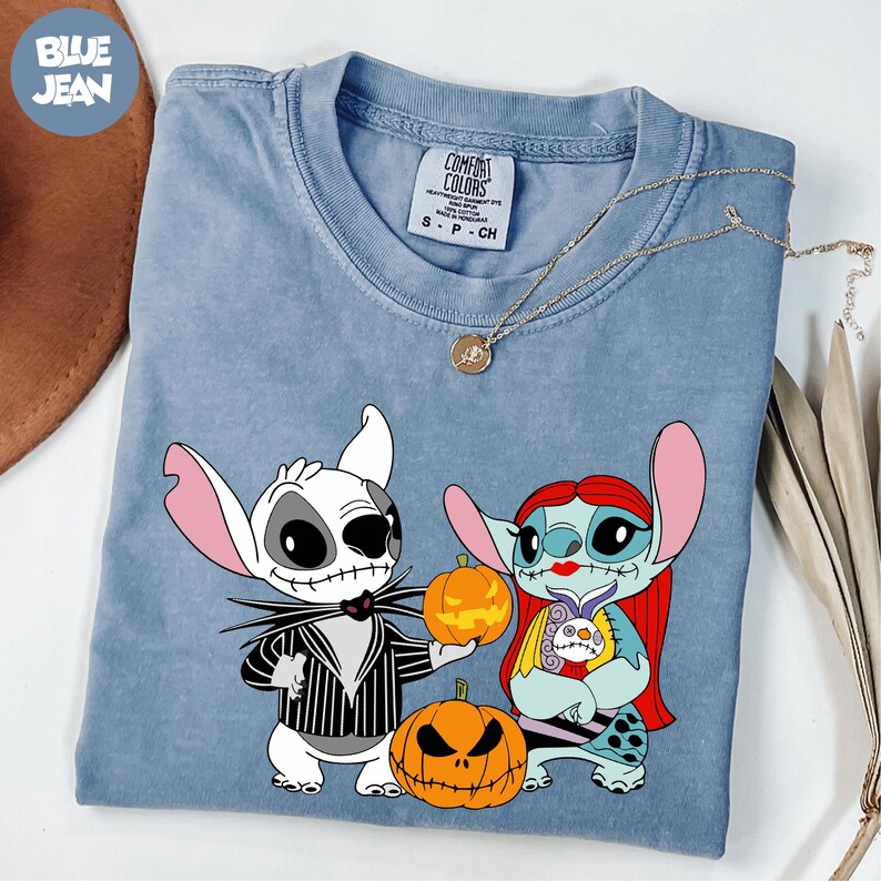 A blue t-shirt with a graphic design featuring characters from the movie " Nightmare Before Christmas".