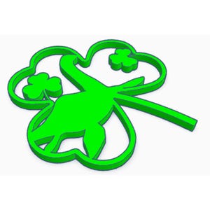 May include: A bright green shamrock-shaped decoration with a dinosaur silhouette in the center. The design features three small shamrocks within the larger clover shape, perfect for St. Patrick's Day.