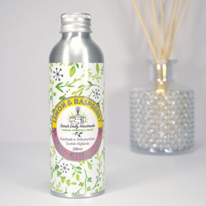 May include: A silver metal bottle with a white label that says "Lemon & Raspberry Reed Diffuser Oil" and "Sarah Emily Handmade". The bottle is 200 ml and is handmade in Aviemore, Scottish Highlands.