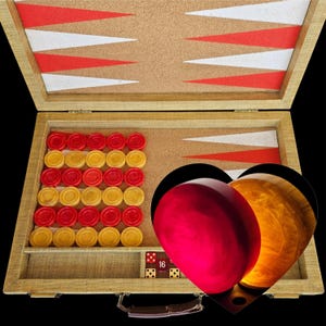 May include: A backgammon set in a tan case with a cork playing surface featuring red and white triangles. The set includes red and yellow circular checkers, a doubling cube with the number 16, and two large heart-shaped resin game pieces.